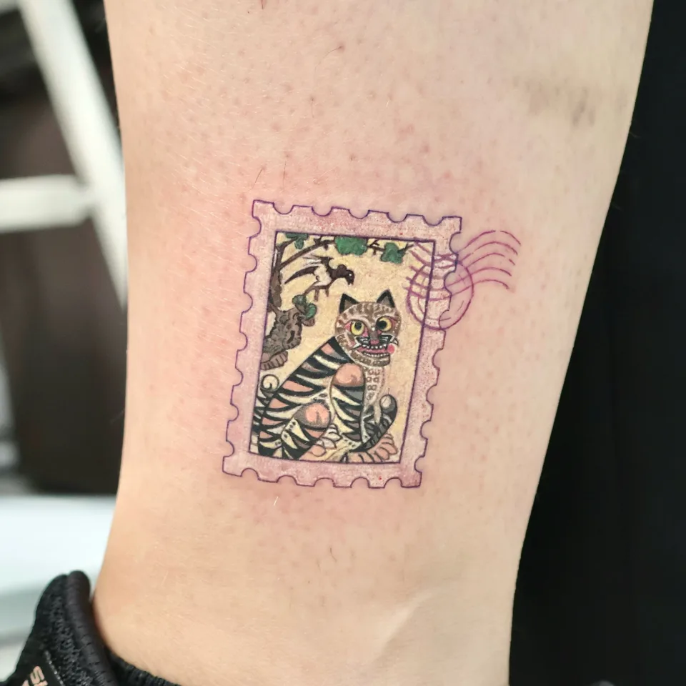 Tattoo artwork shared by Yeonjae Tattoo — A Korean-inspired postage stamp tattoo featuring…